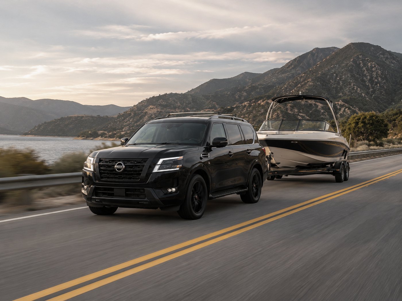 Nissan Armada towing a boat on a mountain highway